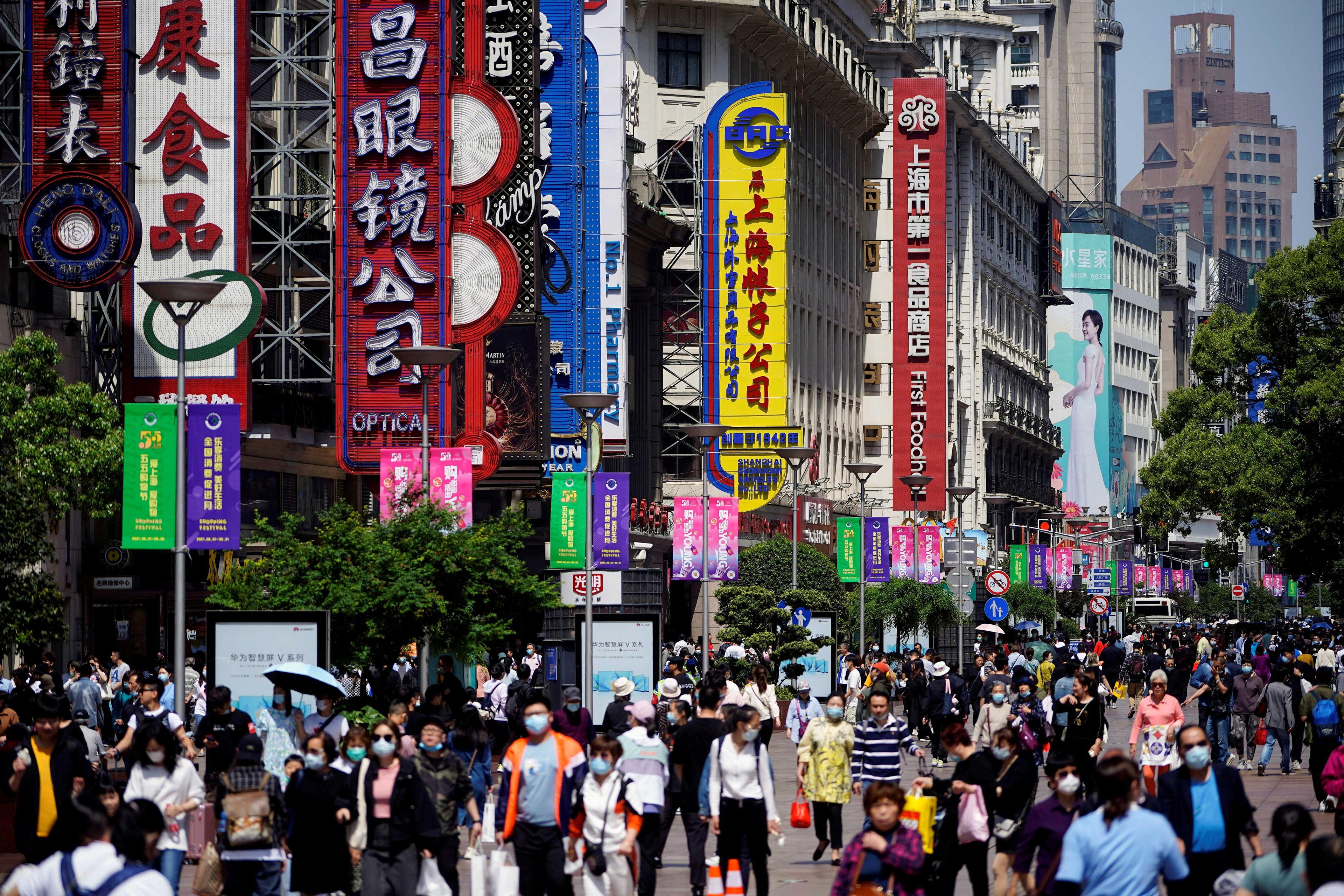People walk along Nanjing Pedestrian Road, a main shopping area, in Shanghai, China May 5, 2021. Photo: Reuters