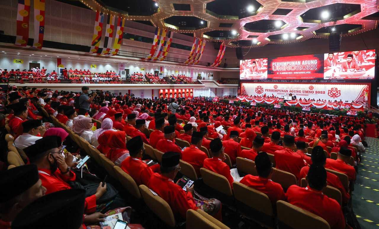 Umno delegates listen as their president Ahmad Zahid Hamidi delivers his presidential address at the 2022 Umno general assembly at the World Trade Centre in Kuala Lumpur. Photo: Bernama