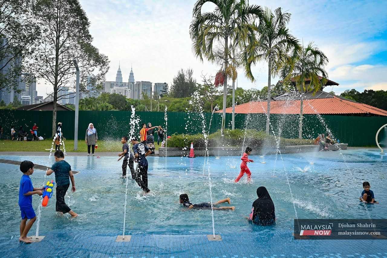 Children play at the water park at Taman Tasik Titiwangsa in Kuala Lumpur. 
