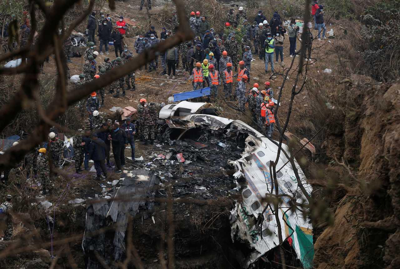 A rescue team works to recover the body of a victim from the site of the plane crash of a Yeti Airlines operated aircraft, in Pokhara, Nepal, Jan 16. Photo: Reuters