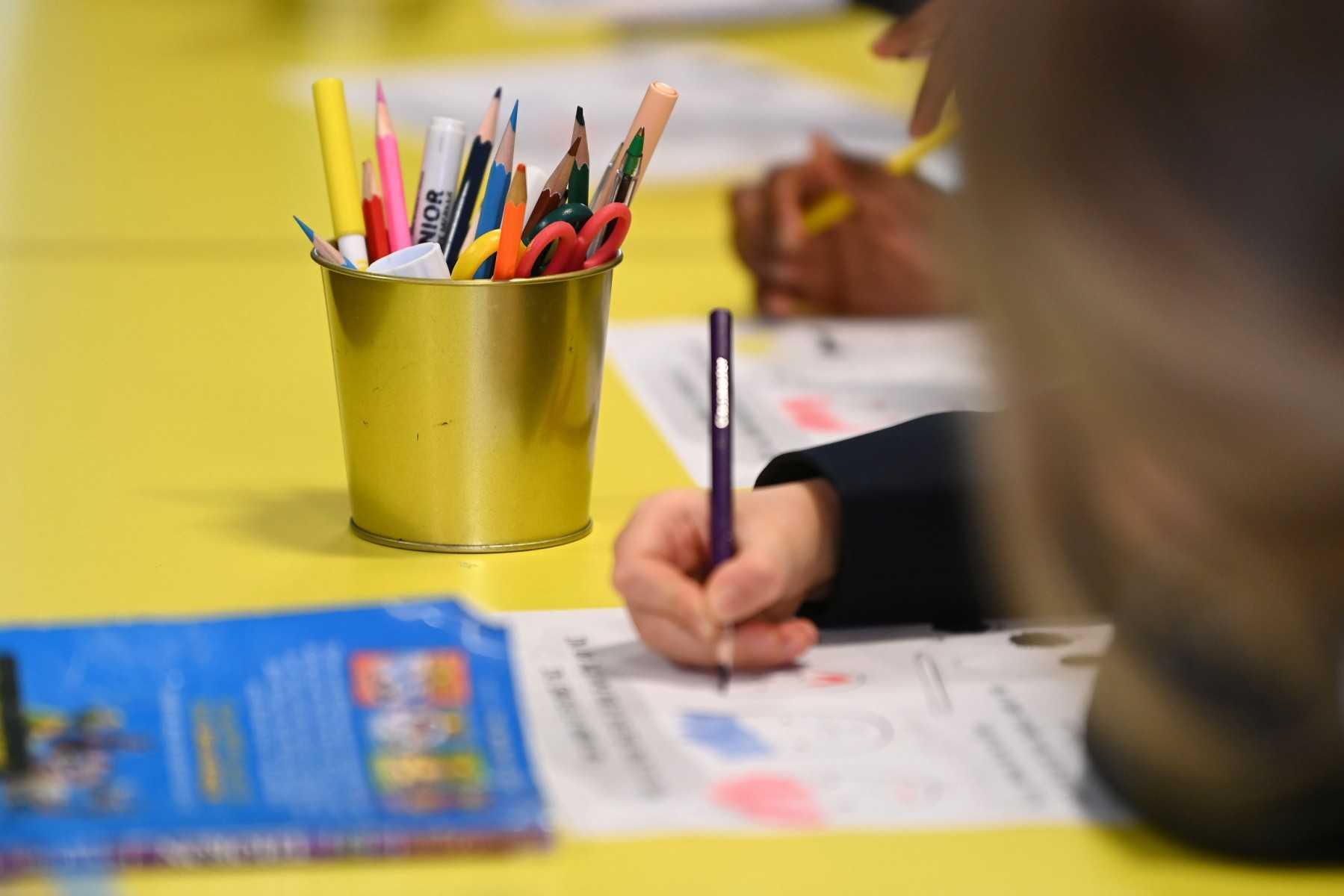 Students sit at their desks at Halley House School in east London, on March 8, 2021. Photo: AFP