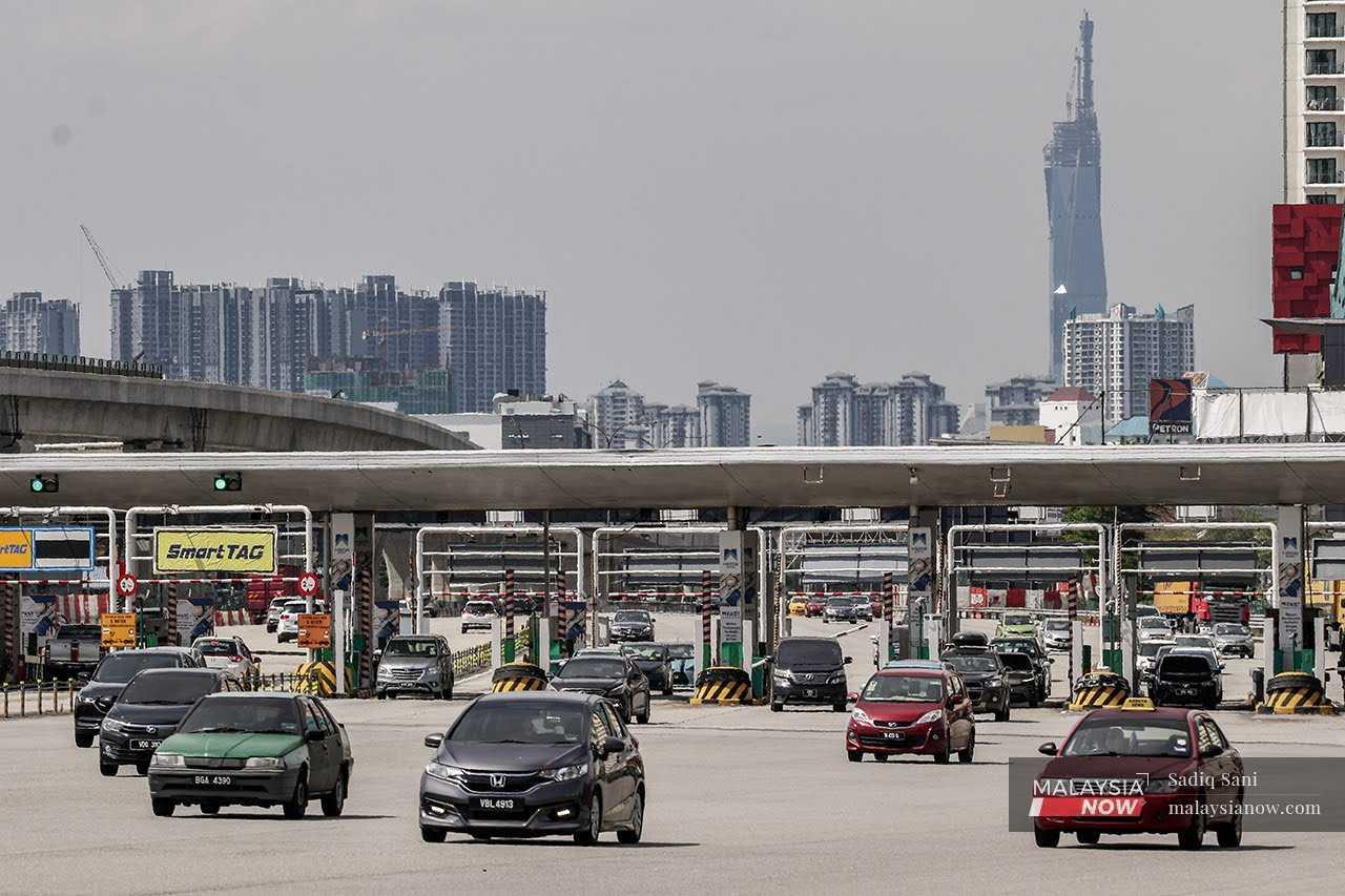 Vehicles pass through the Sungai Besi toll plaza in Kuala Lumpur.