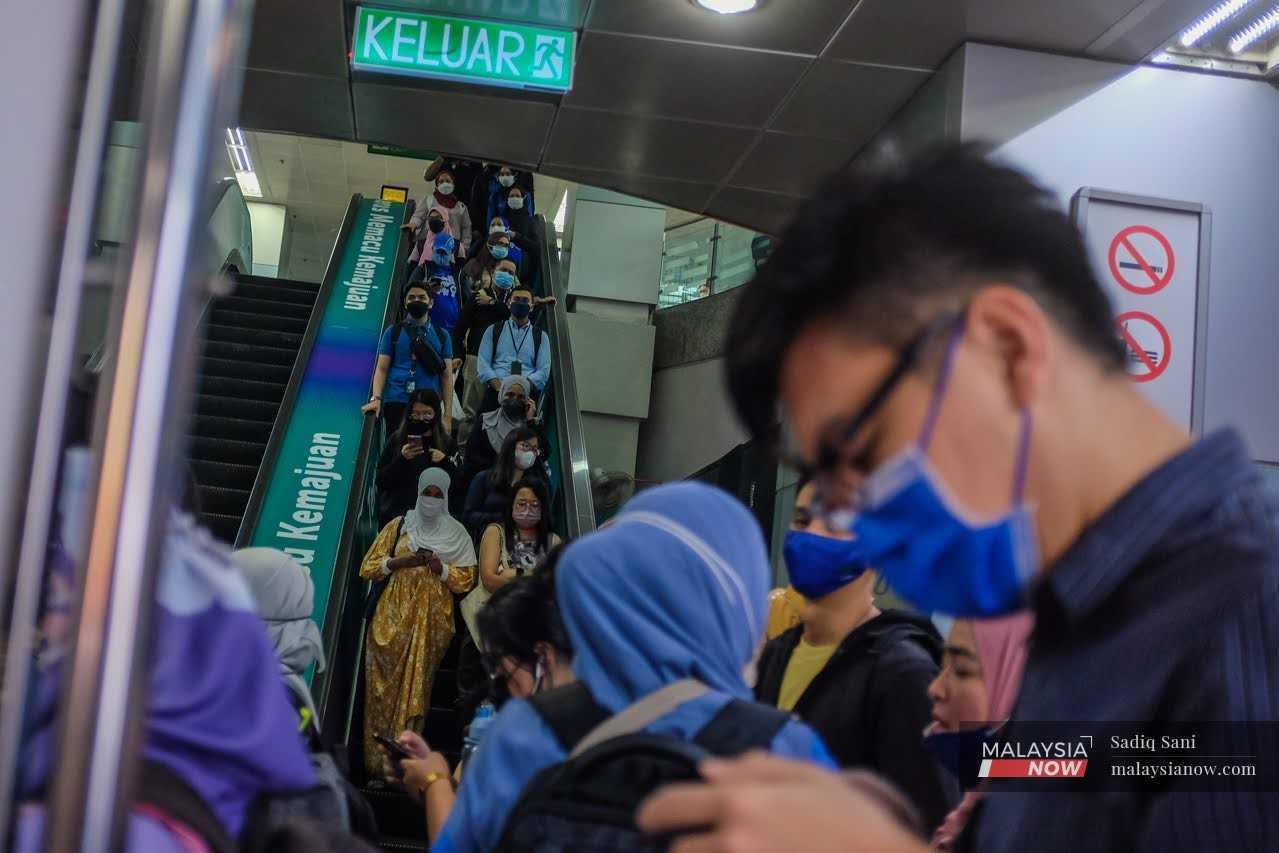 Commuters fill the KLCC LRT station in Kuala Lumpur after a day of work in the capital city.