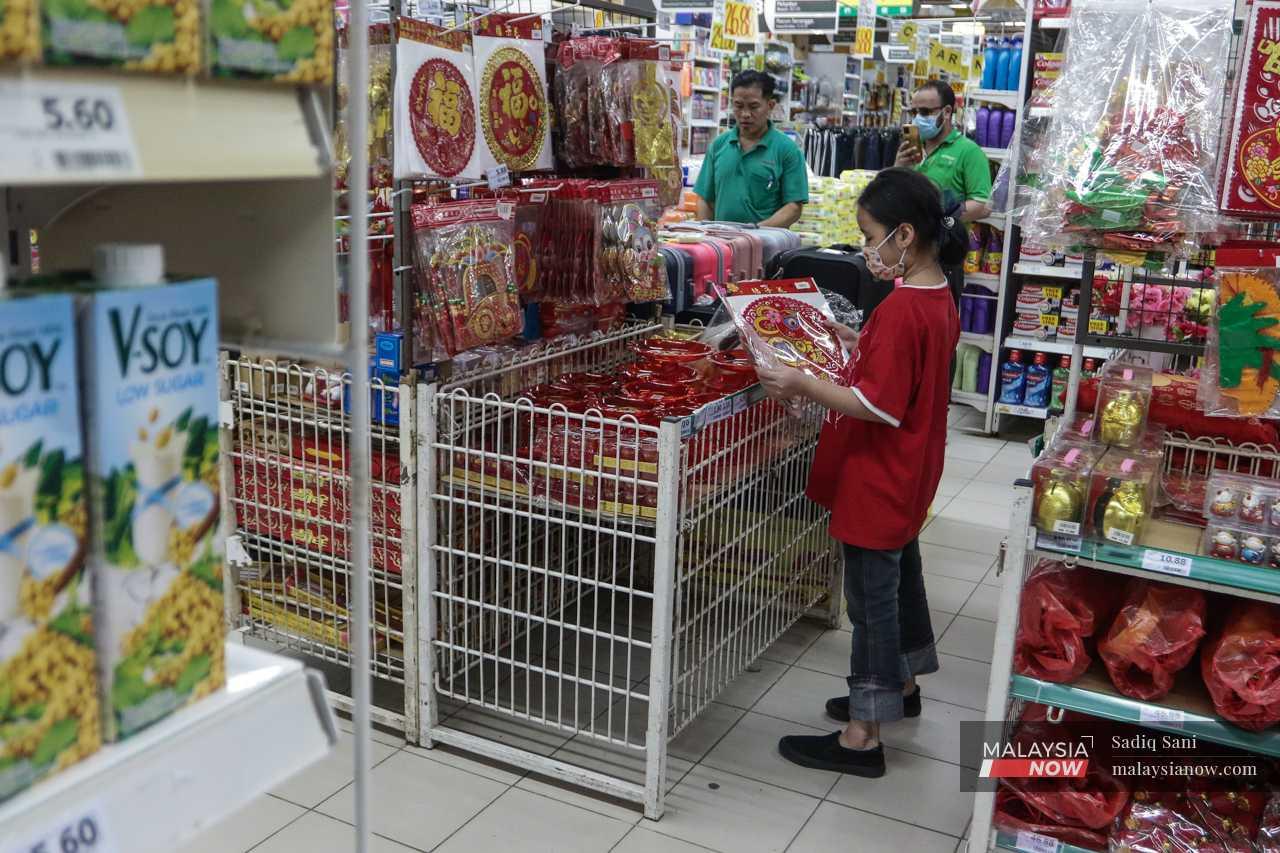After she finishes her homework, she goes to a nearby supermarket to get some Chinese New Year decorations for the house. 