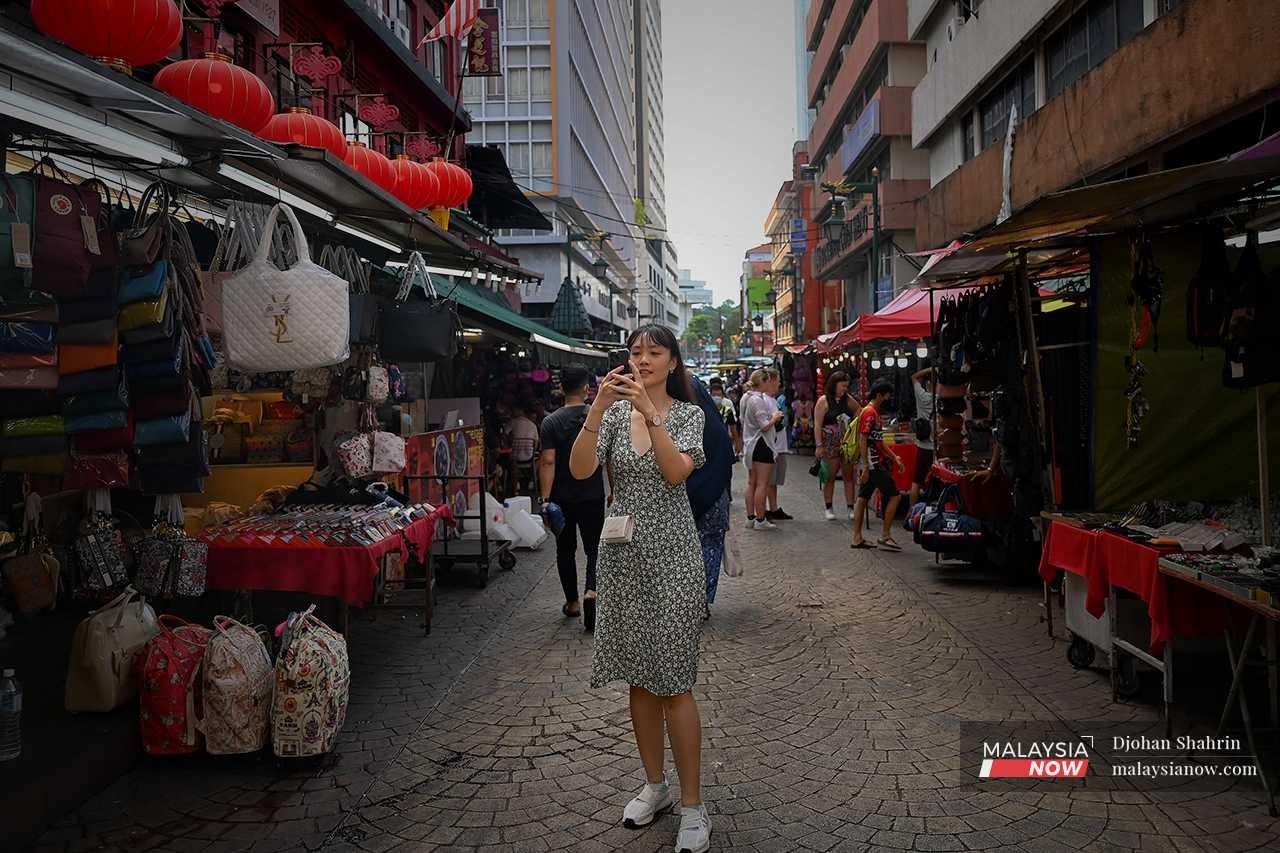 As she walks, she takes a video to upload on social media, where she has a large following on TikTok and Instagram. 