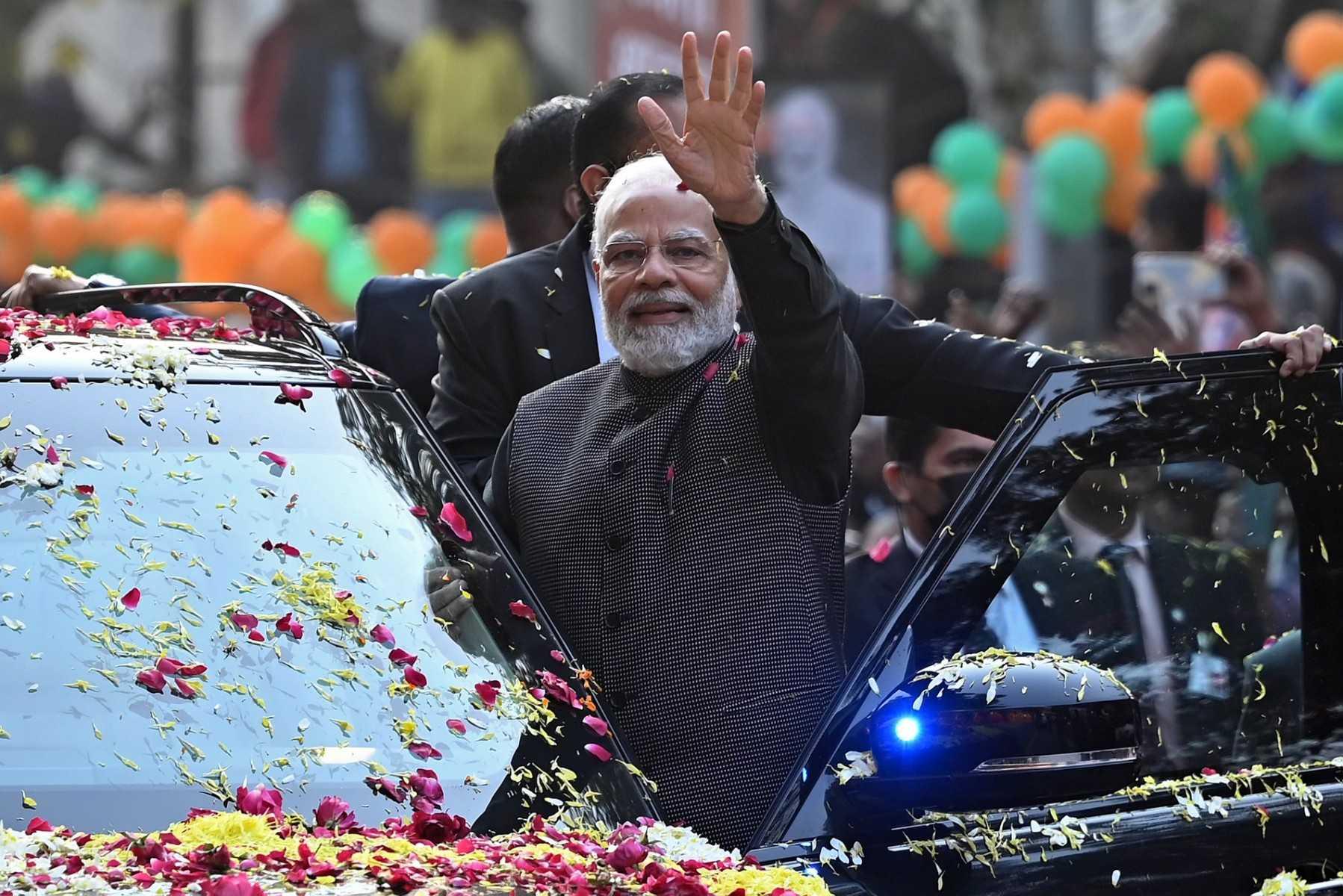 India's Prime Minister Narendra Modi waves to his supporters during a roadshow ahead of the BJP national executive meet in New Delhi on Jan 16. Photo: AFP