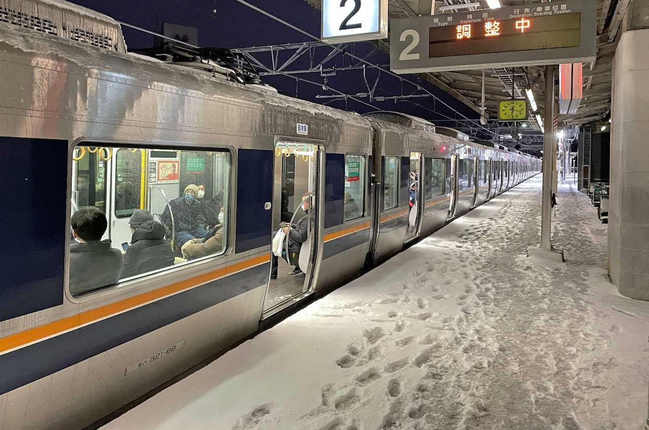 A train is stranded at Nishioji station in Kyoto, Japan in this photo provided by Kyodo on Jan 25. Photo: Reuters