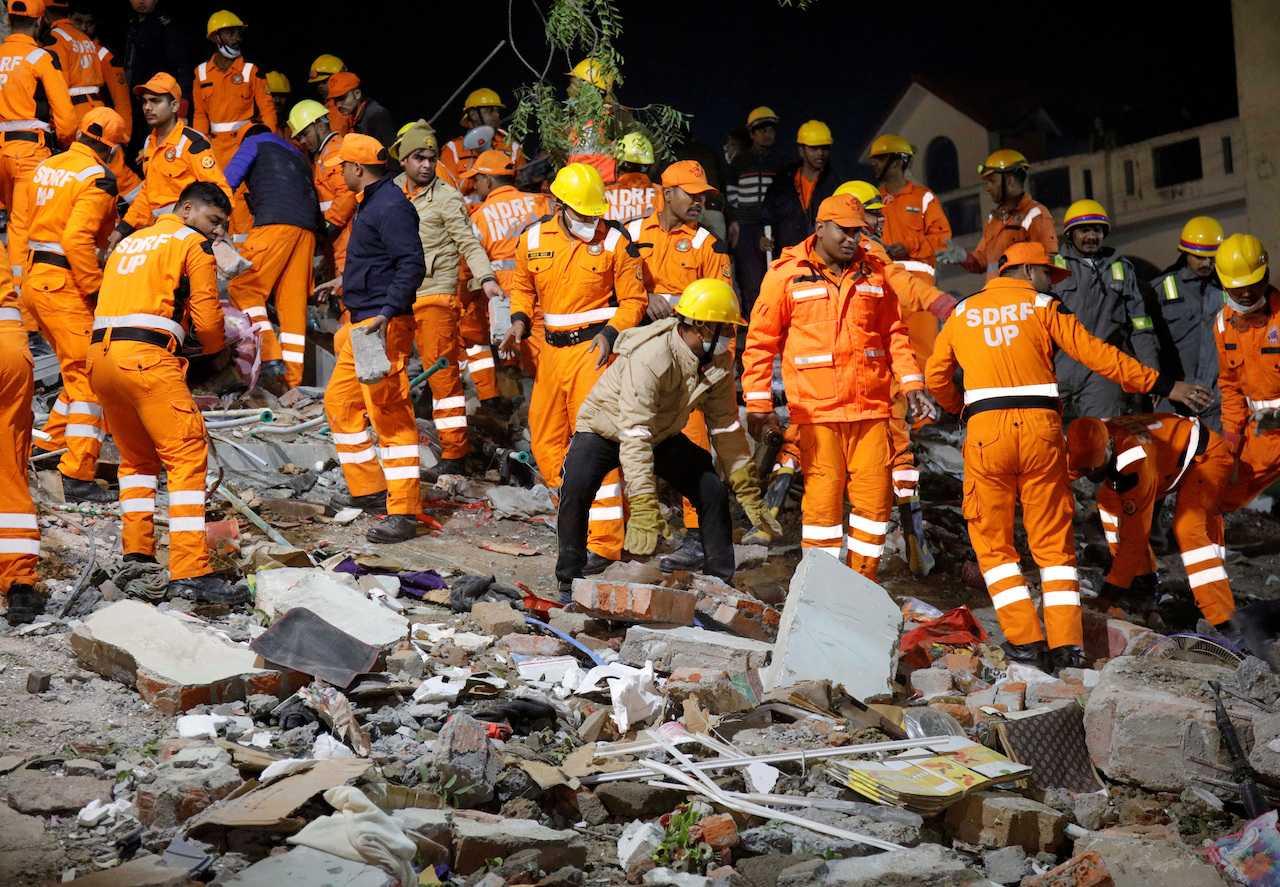 Rescue members remove the debris after a residential apartment block collapsed in Lucknow, India, Jan 24. Photo: Reuters