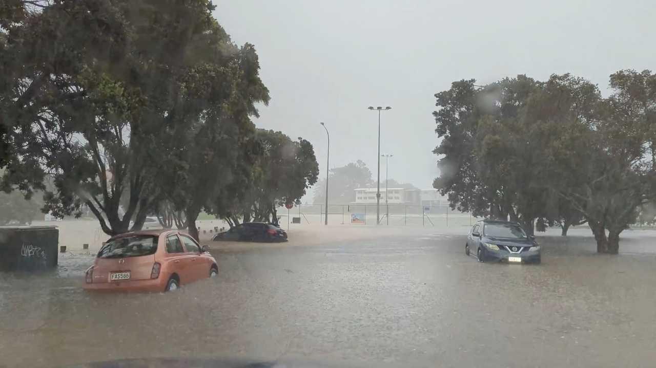 Cars are seen in a flooded street during heavy rainfall in Auckland, New Zealand, Jan 27, in this screengrab obtained from a social media video. Photo: Reuters