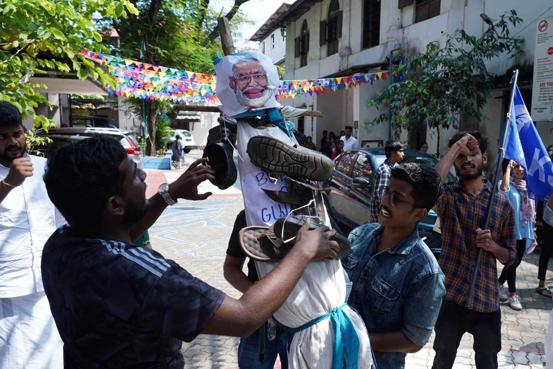 In this picture taken on Jan 25, Kerala Students' Union activists place a garland of footwear on an effigy of India's Prime Minister Narendra Modi after watching the BBC documentary 'India: The Modi Question', at Ernakulam Law College in Kochi. Photo: AFP