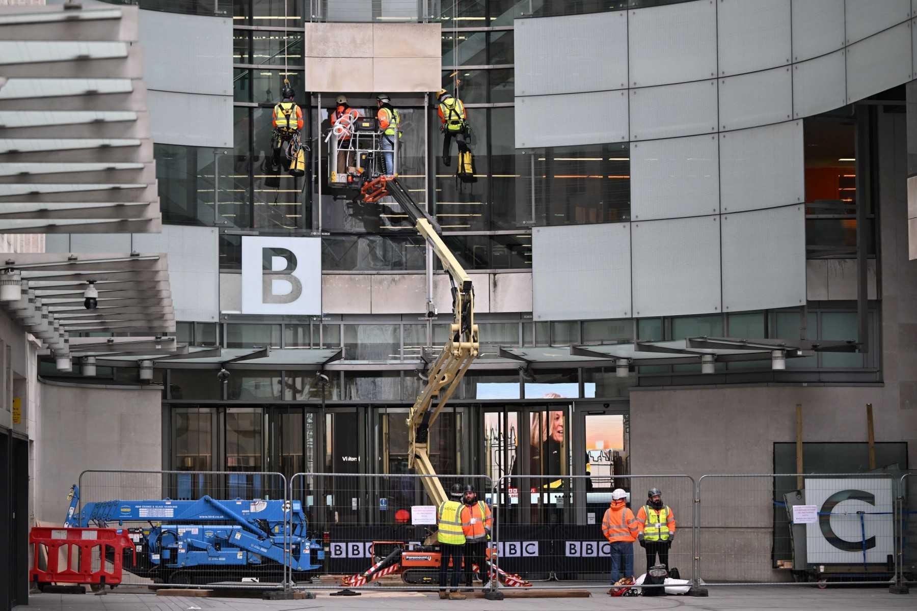 Workmen are seen doing repairs to the front of the BBC studios in central London on Jan 29. Photo: AFP 