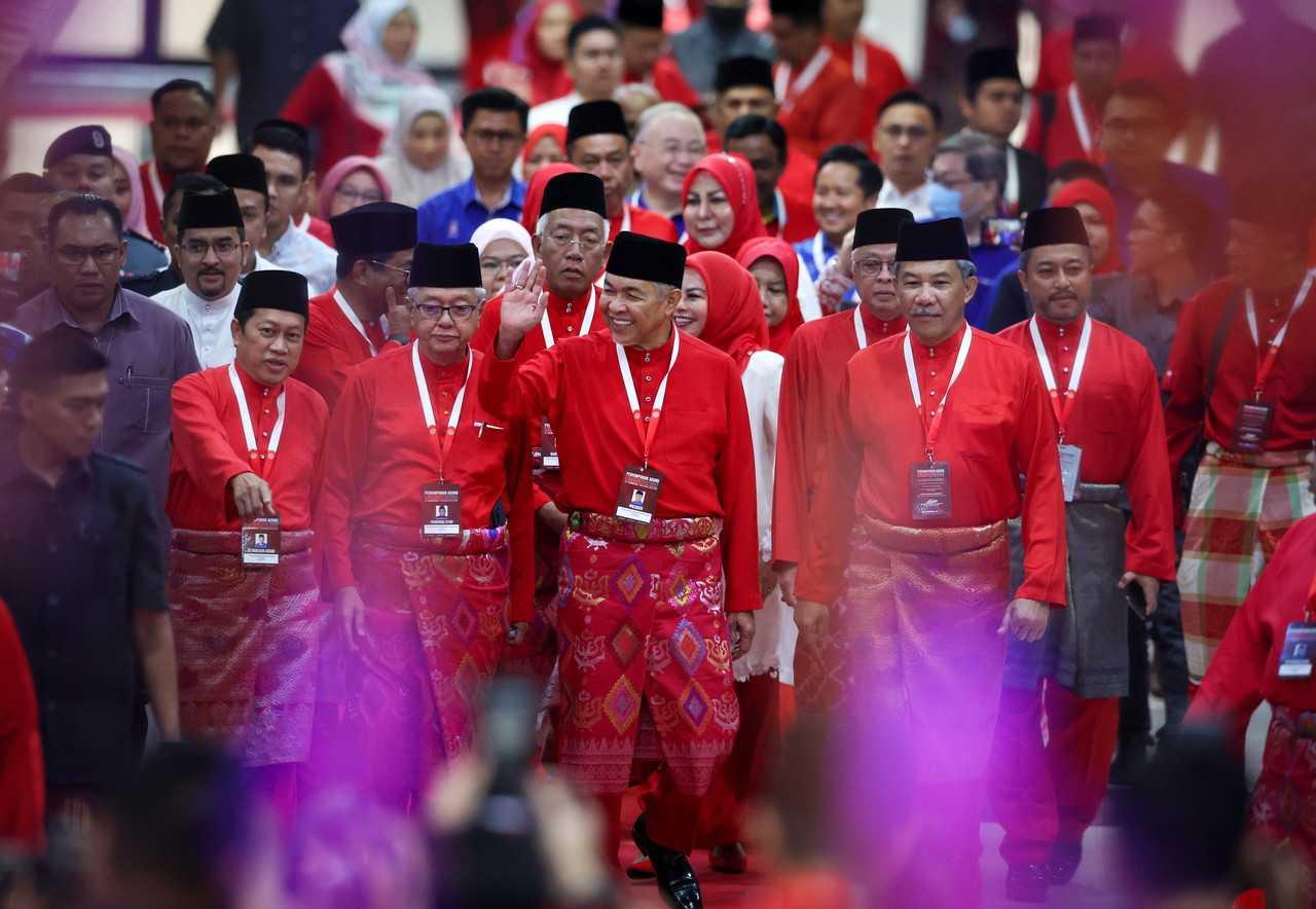 Umno president Ahmad Zahid Hamidi (centre) flanked by his deputy Mohamad Hasan arrives at the World Trade Centre in Kuala Lumpur for the party's 2022 general assembly, Jan 13. Photo: Bernama