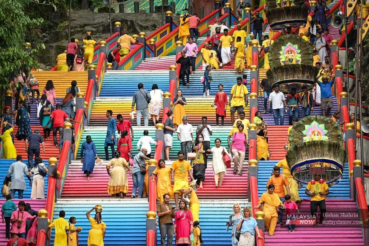 Devotees and tourists mingle on the colourful stairs leading up to the temple. 