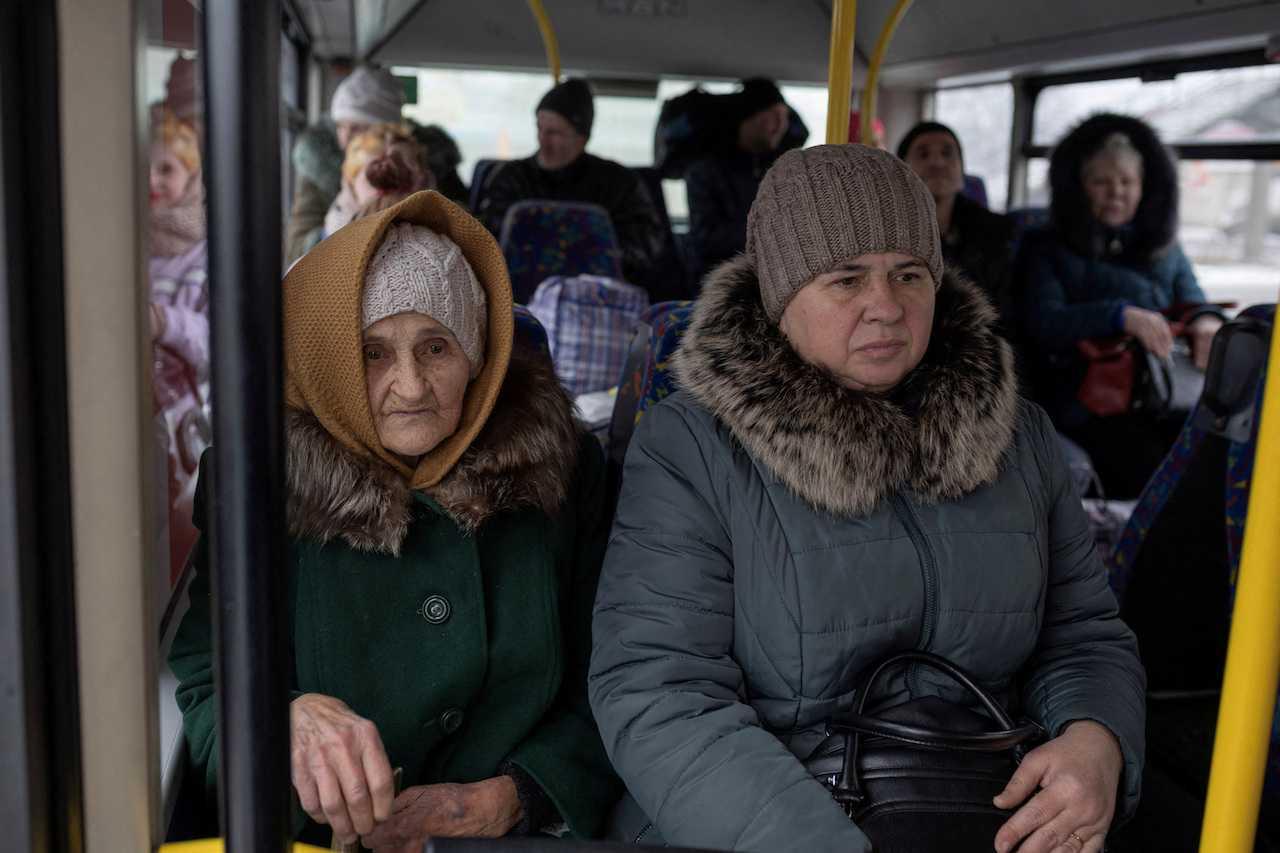 People sit in a bus during an evacuation, amid Russia's attack on Ukraine, in Kostiantynivka, Donetsk region, Ukraine, Feb 4. Photo: Reuters