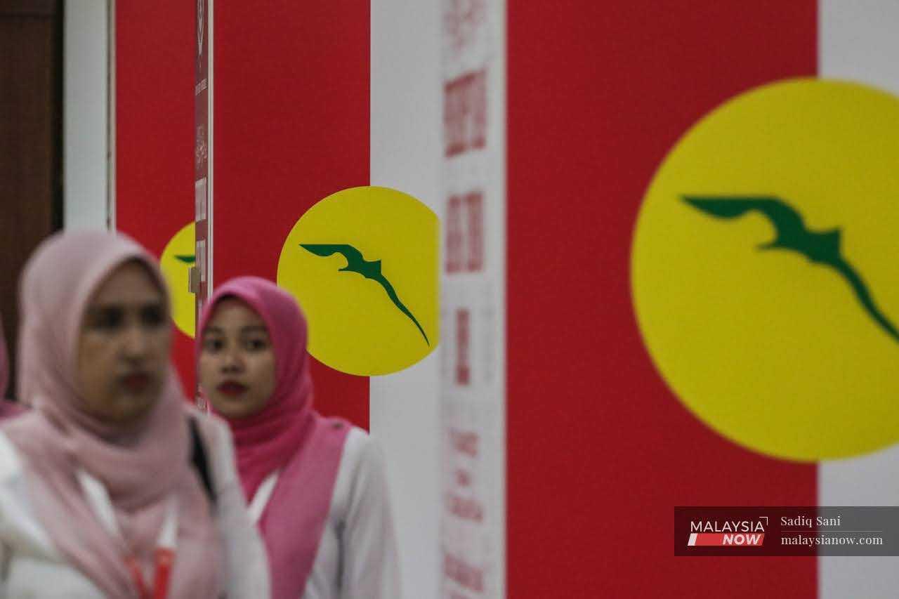 Delegates mingle during the 2022 Umno general assembly at the World Trade Centre in Kuala Lumpur, Jan 11.