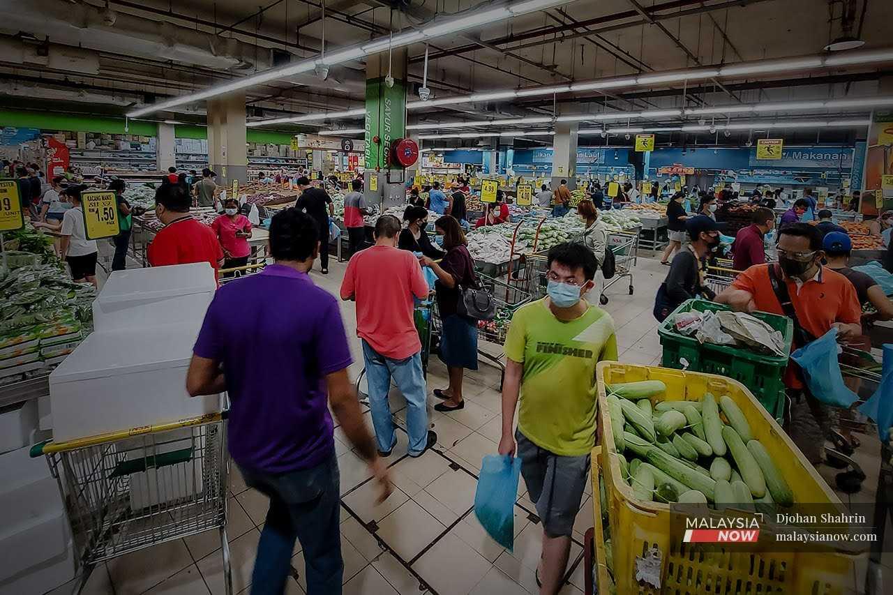 Customers pick up their groceries at a supermarket in Taman Kuchai, Kuala Lumpur.