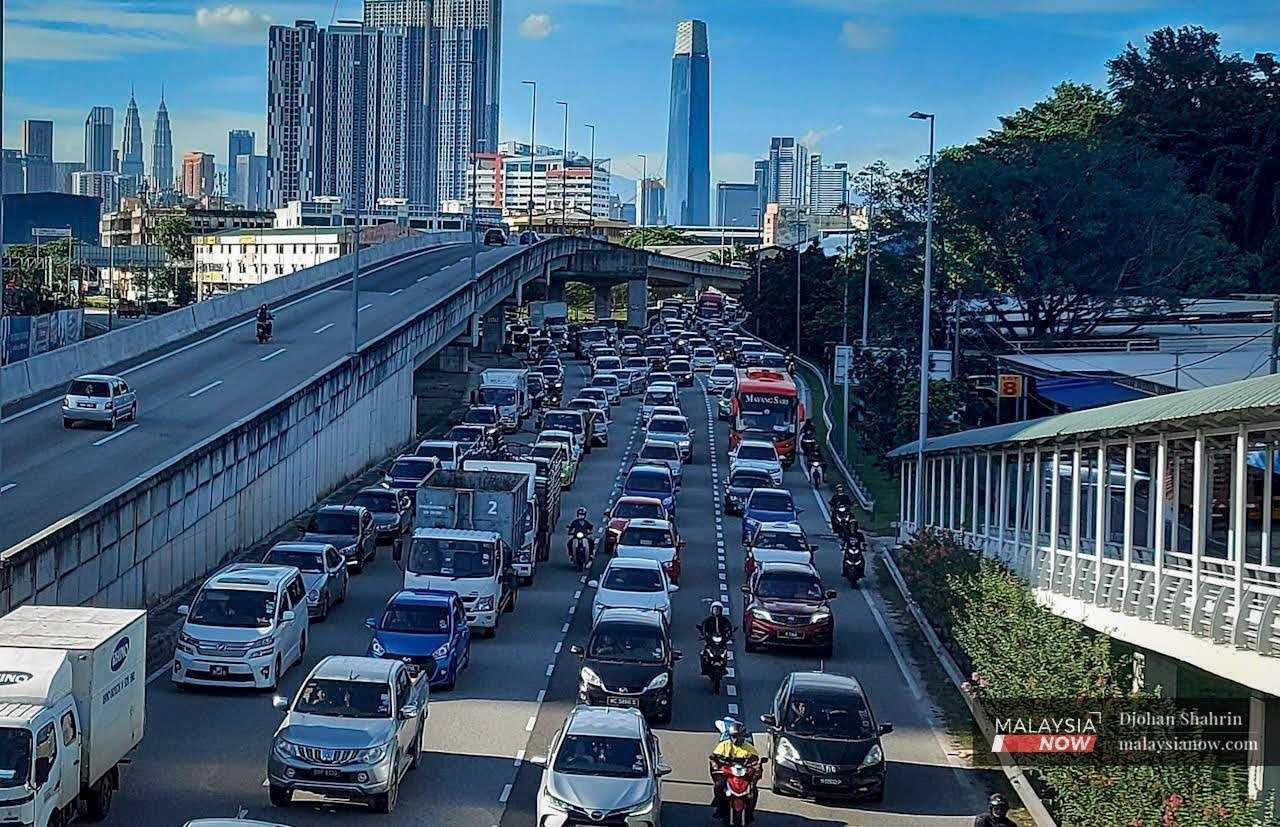 Traffic moves along a major road in the capital city of Kuala Lumpur. 
