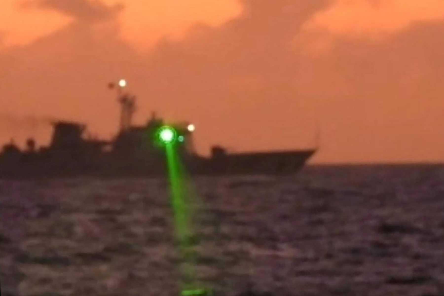 This handout photo taken on Feb 6, and released by the Philippine Coast Guard on Feb 13 shows a Chinese Coast Guard vessel shining a 'military grade laser light' at a Philippine Coast Guard boat nearly 20km from Second Thomas Shoal, in the Spratly Islands in the disputed South China Sea. Photo: AFP