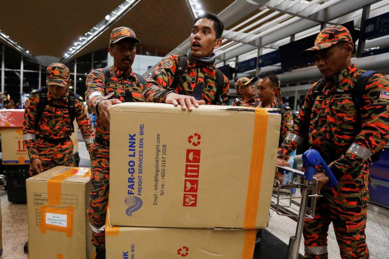 Rescue personnel move boxes of food as they are deployed for a search and rescue mission to quake-hit Turkey, at KLIA, Sepang, Feb 8. Photo: Reuters