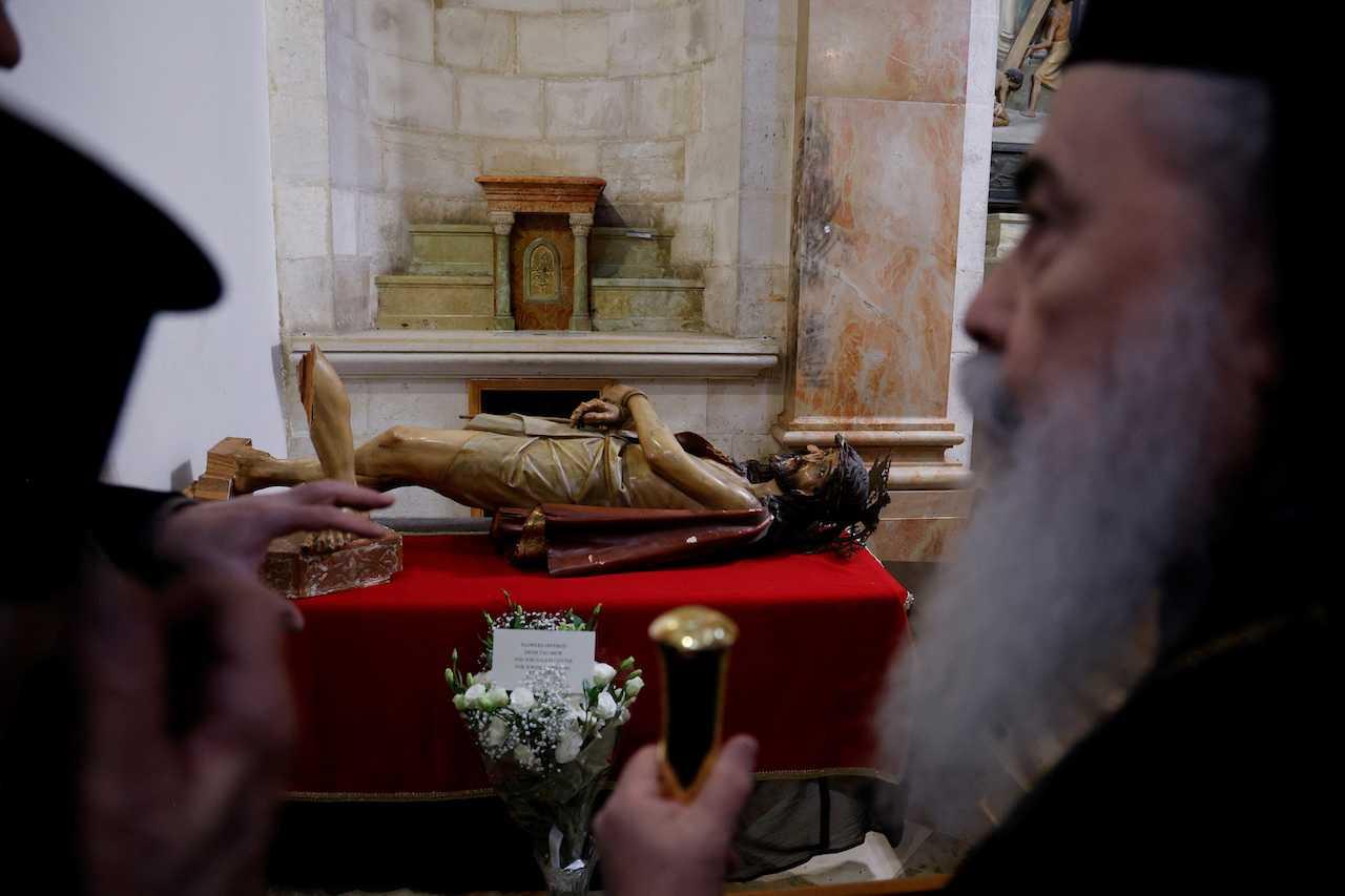 The Greek Orthodox Patriarch of Jerusalem, Theophilus, visits the Church of the Flagellation to see a statue of Jesus which was, according to church authorities, vandalised by a Jewish radical who was later detained, in Jerusalem, Feb 4. Photo: Reuters