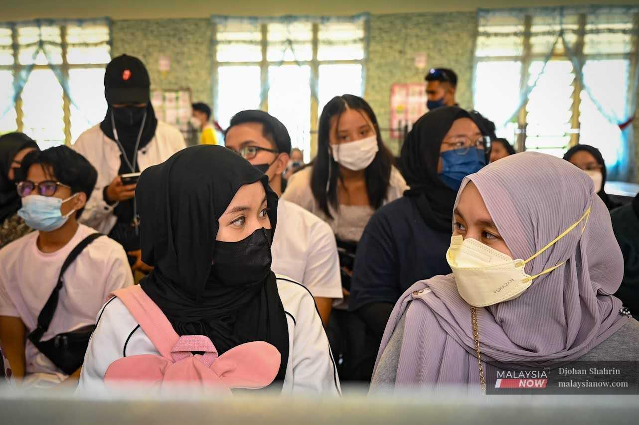 First-time voters wait for their turn to cast their ballots at a voting centre in Kampung Baru, Kuala Lumpur, during the general election on Nov 19, 2022.
