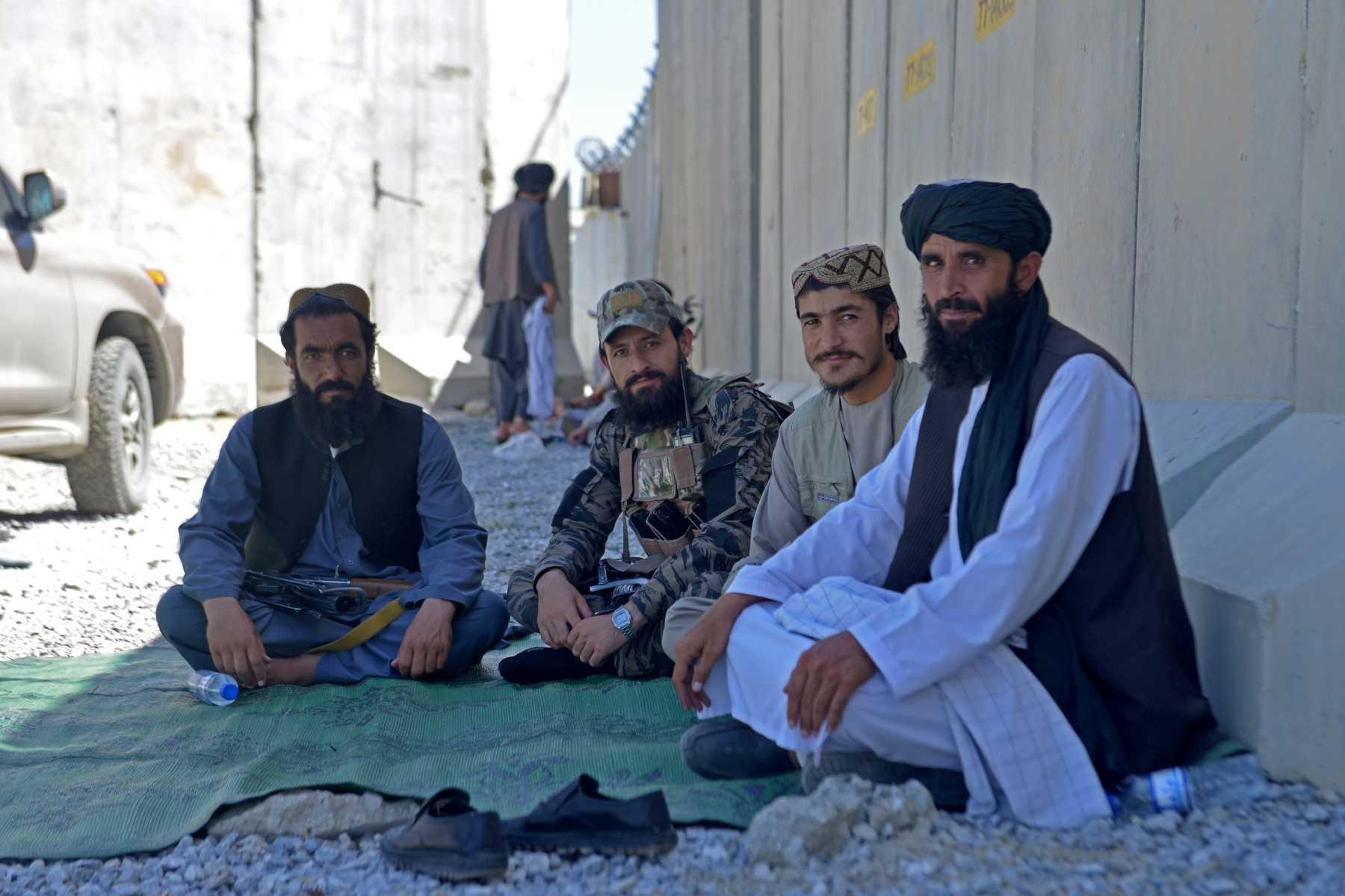 Members of Taliban sit outside the former US military base to celebrate the first anniversary of the withdrawal of US-led troops from Afghanistan, in Bagram on Aug 31, 2022. Photo: AFP 