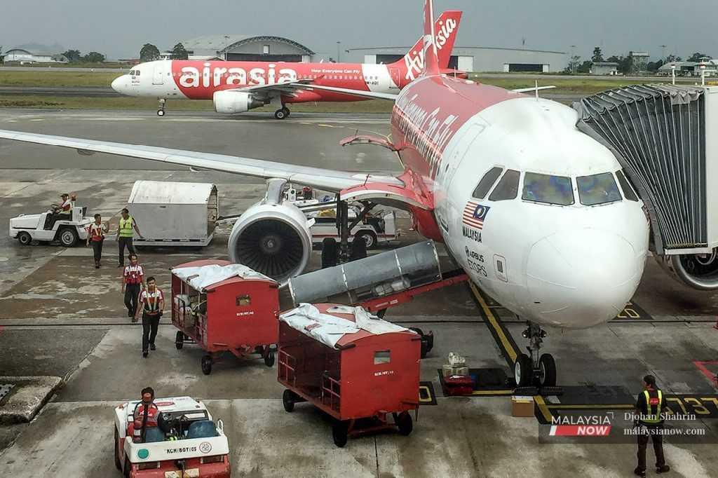 AirAsia planes sit on the tarmac as they undergo final checks before departing for their destinations at klia2 in Sepang.