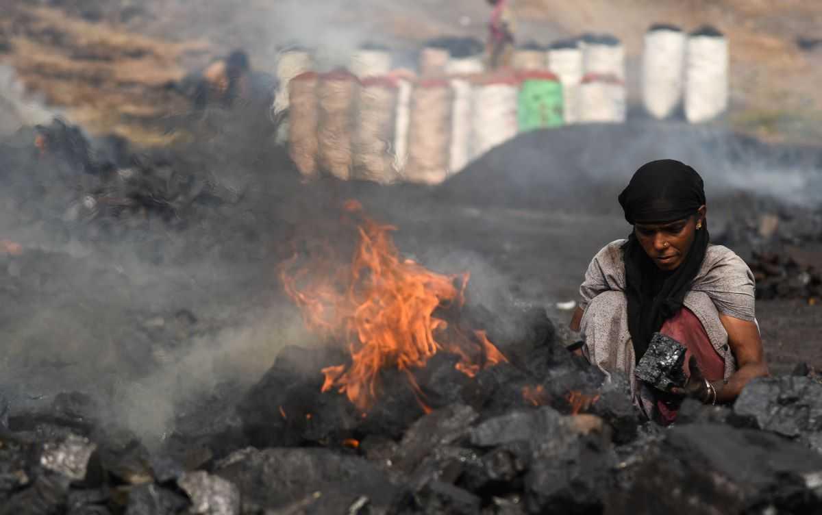 A coal scavenger burns coal before selling it for use at a depot in a mining area of Jharia coalfield, India, Nov 11, 2022. Photo: Reuters