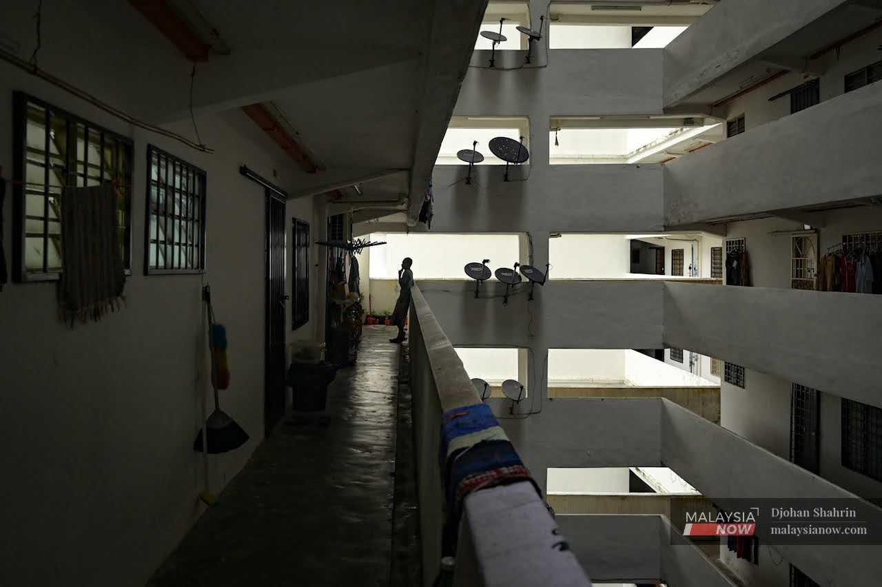 A resident stands in the corridor of a low-cost housing project in Pantai Dalam, Kuala Lumpur.