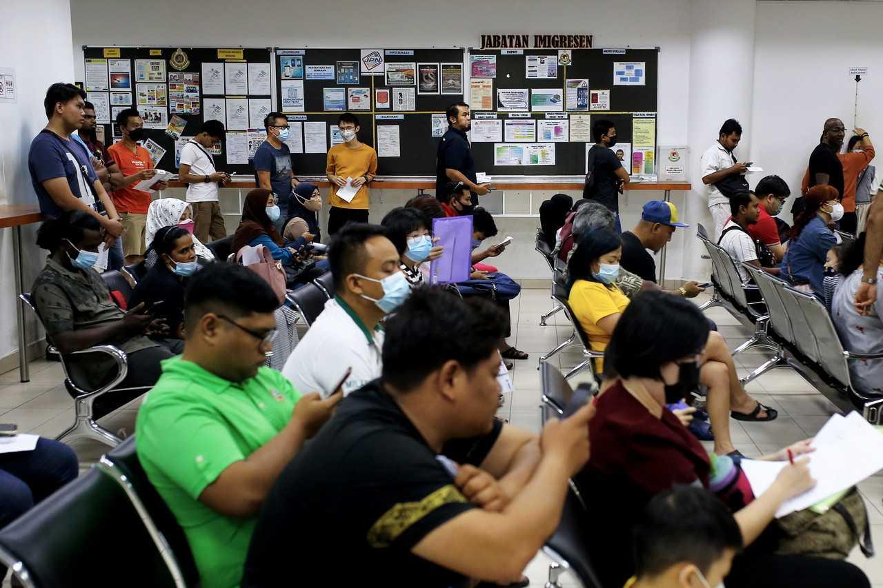 People wait for their turn at an immigration department counter in Seremban, Jan 31. Photo: Bernama