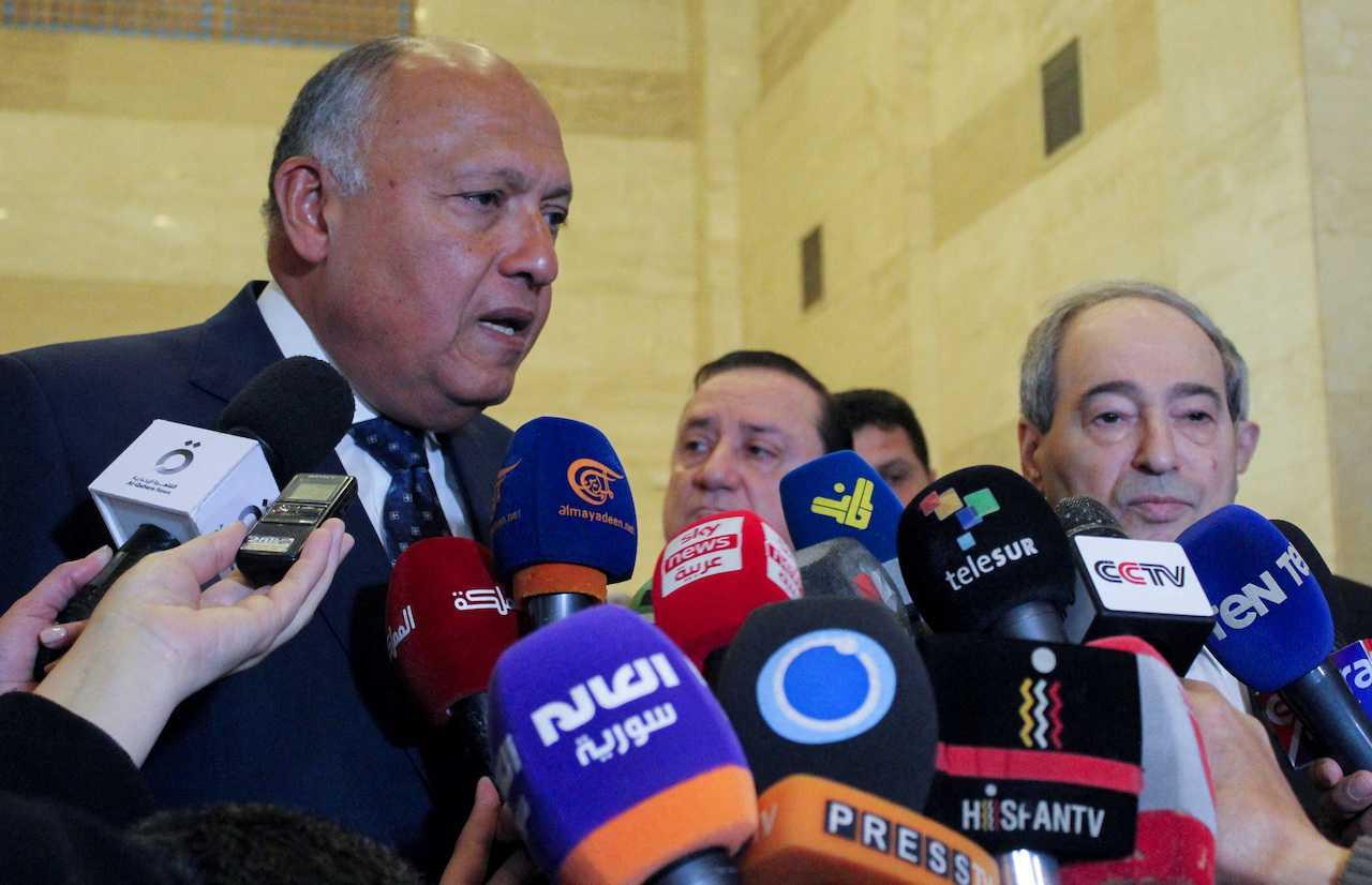 Egypt's Foreign Minister Sameh Shoukry stands next to Syrian Foreign Minister Faisal Mekdad as he speaks during a joint news conference in Damascus, Syria, Feb 27. Photo: Reuters
