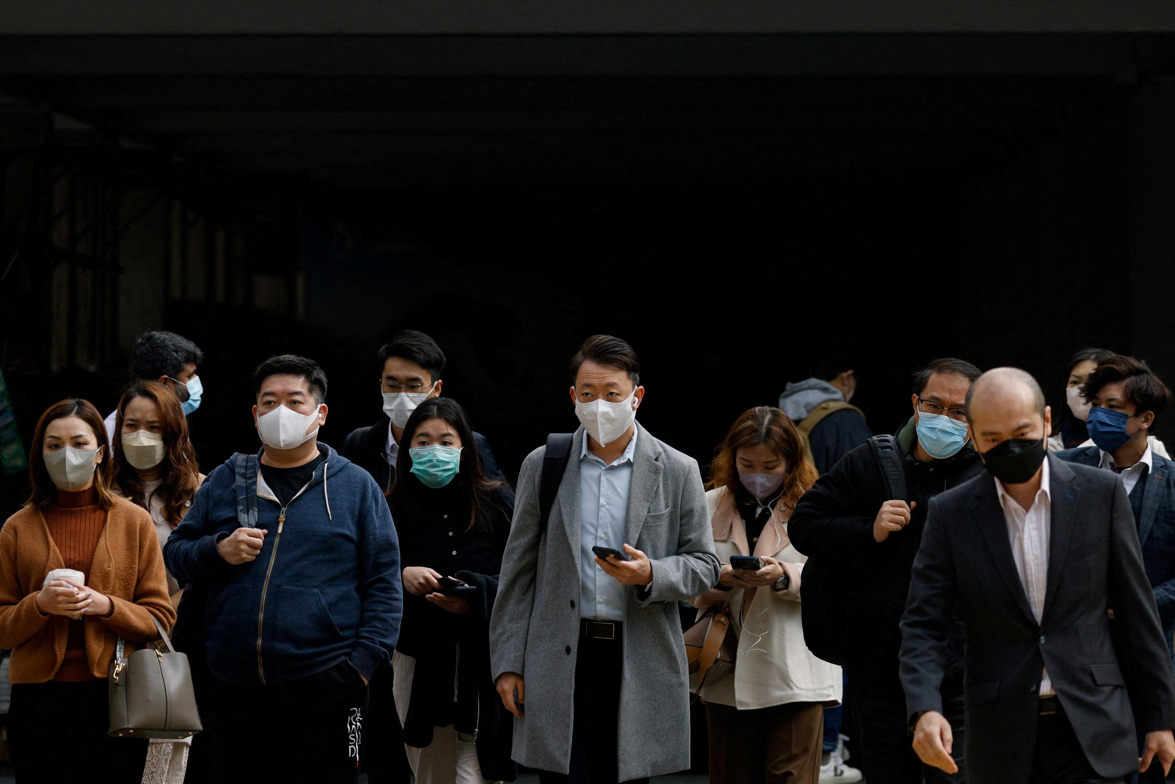 People wear face masks on the street, a day before government scraps the mask rule in Hong Kong, China Feb 28. Photo: Reuters