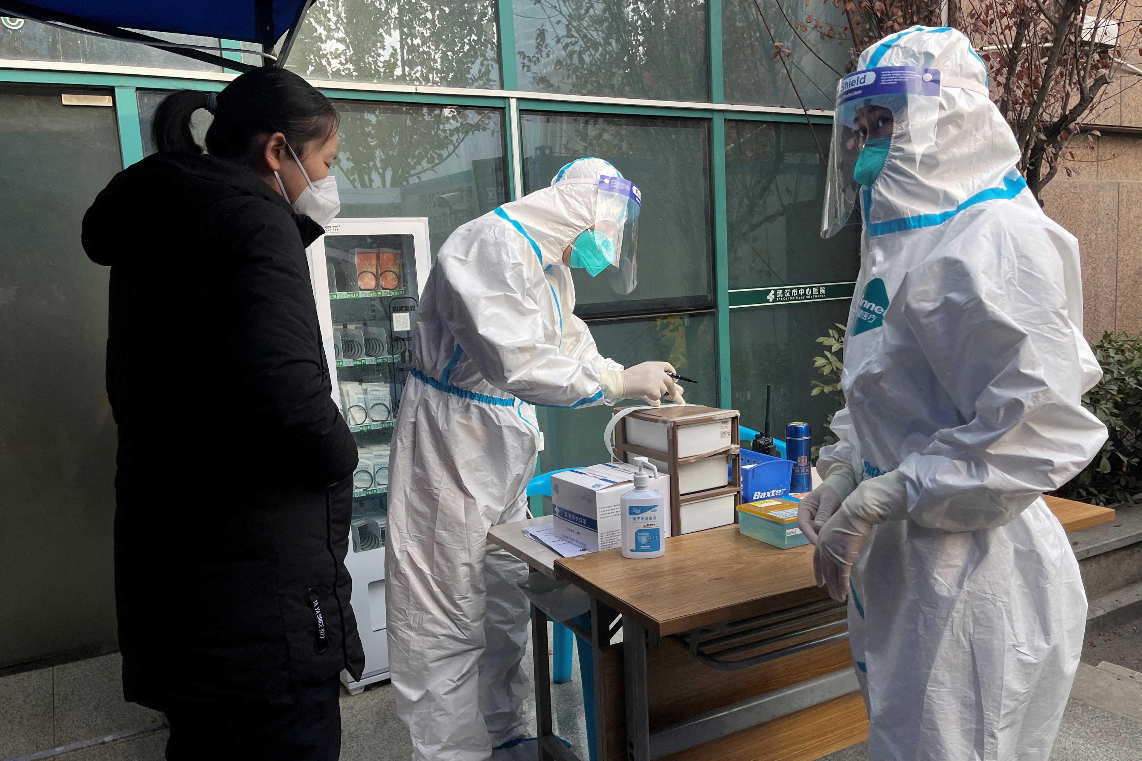 A medical worker in a protective suit registers information for a patient at the entrance to the fever clinic of the Central Hospital of Wuhan, amid the Covid-19 outbreak, in Wuhan, Hubei province, China Dec 31, 2022. Photo: Reuters