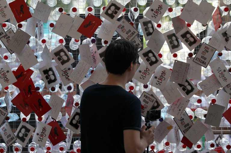 A visitor reads postcards showing support for HIV positive people during a World Aids Day campaign in Kuala Lumpur, Dec 1, 2012. Photo: AFP