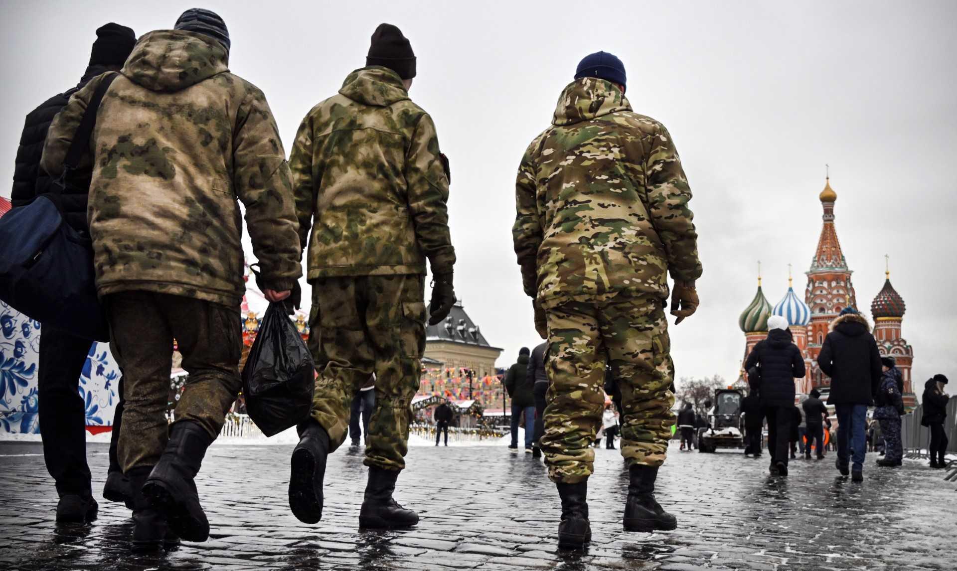 Men wearing military uniform walk along Red Square in front of St Basil's Cathedral in central Moscow on Feb 13. Photo: AFP