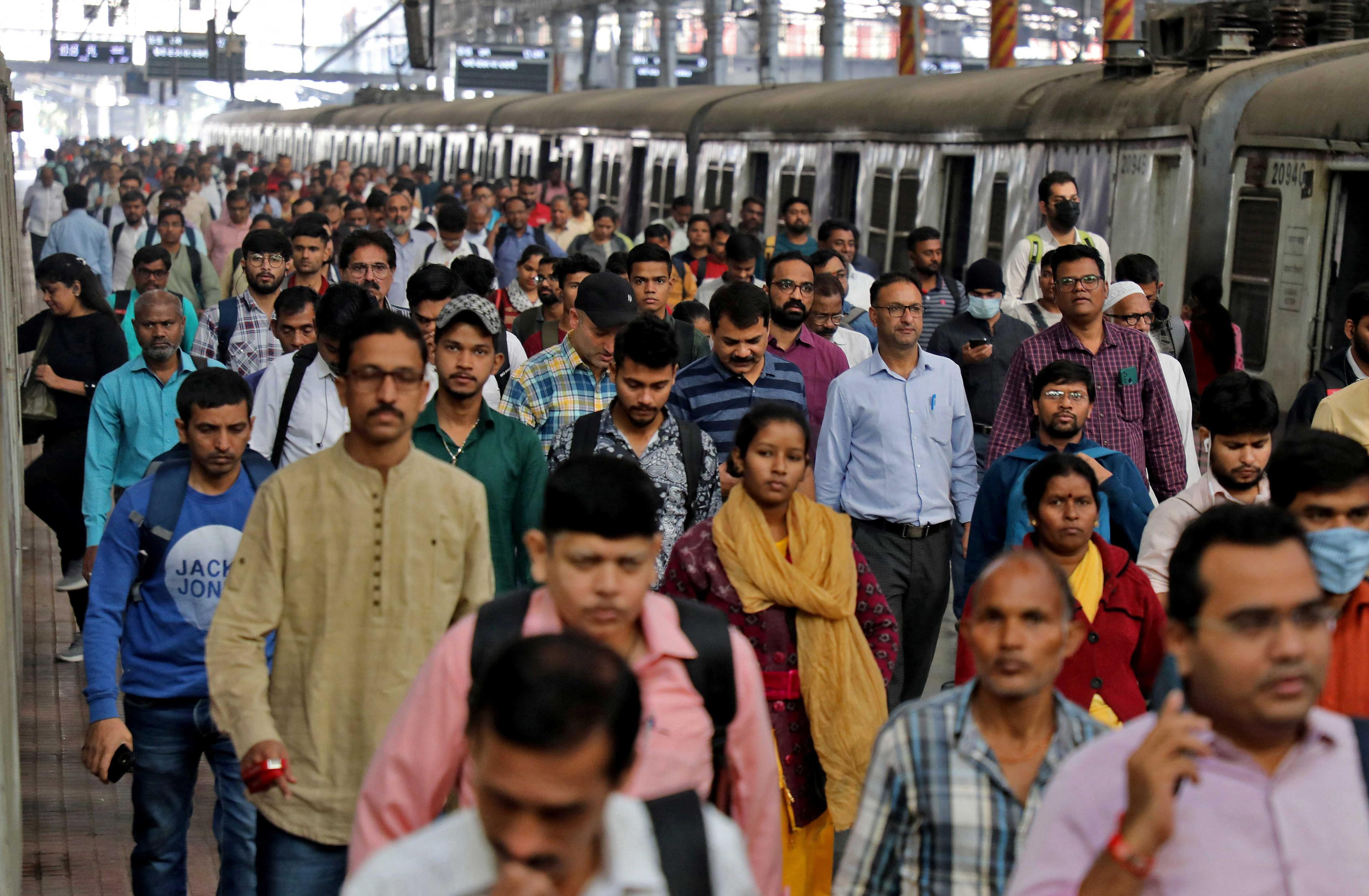 Commuters walk on a platform after disembarking from a suburban train at a railway station in Mumbai, India, Jan 21. Photo: Reuters
