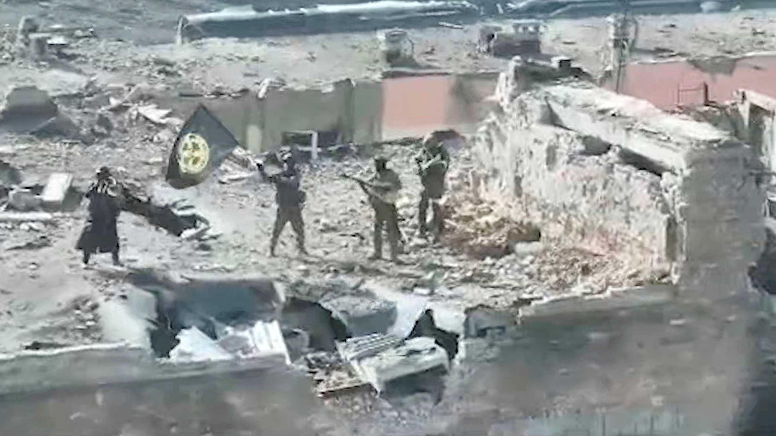 A still image taken from video released by founder of Russia's Wagner Group Yevgeny Prigozhin's press service, shows what it said to be Wagner fighters standing with a flag on top of a building in Bakhmut, Ukraine, in this still image taken from video released March 2. Photo: Reuters