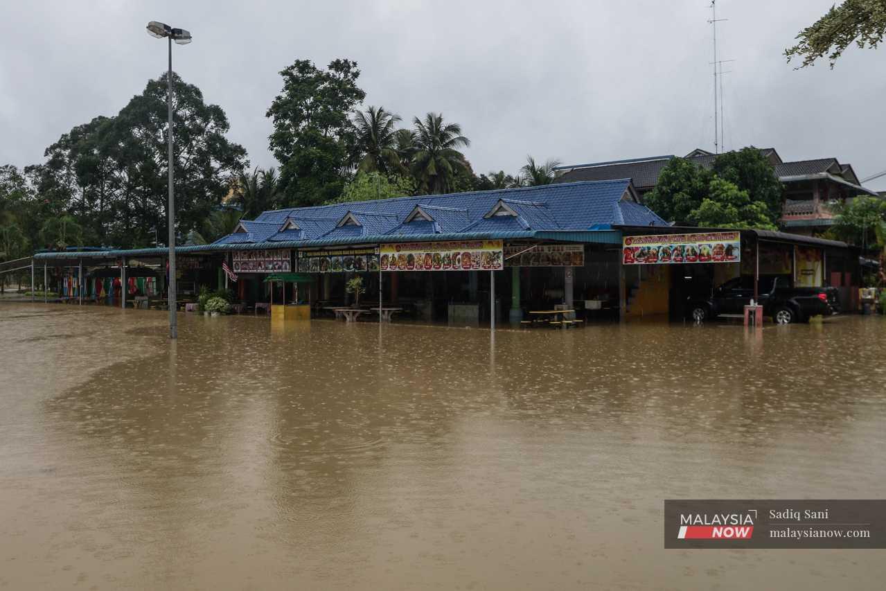 A food court stands partially submerged in water in Yong Peng, Johor.