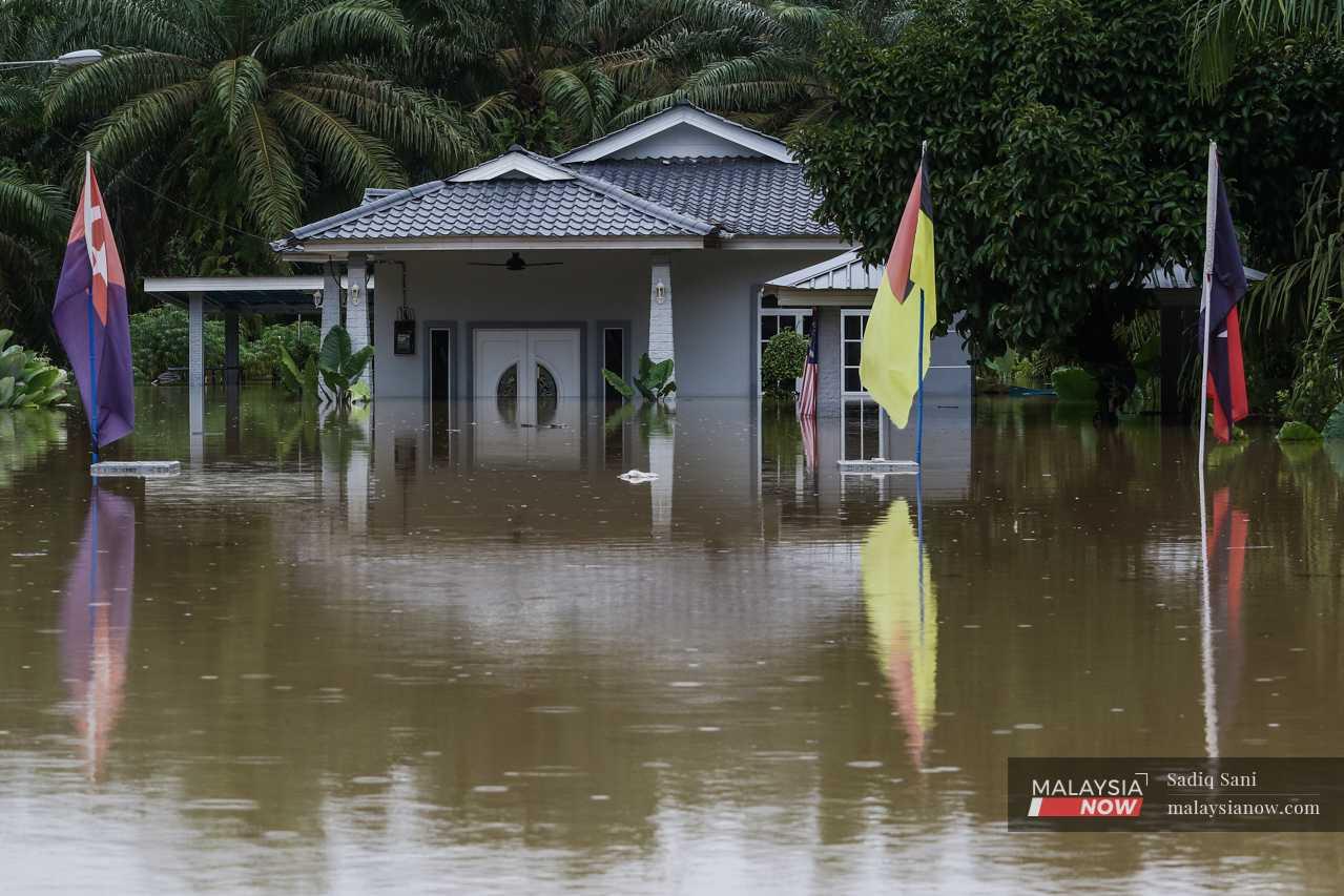 Water rises midway up the front door of a house near Kampung Temehel in Yong Peng. 