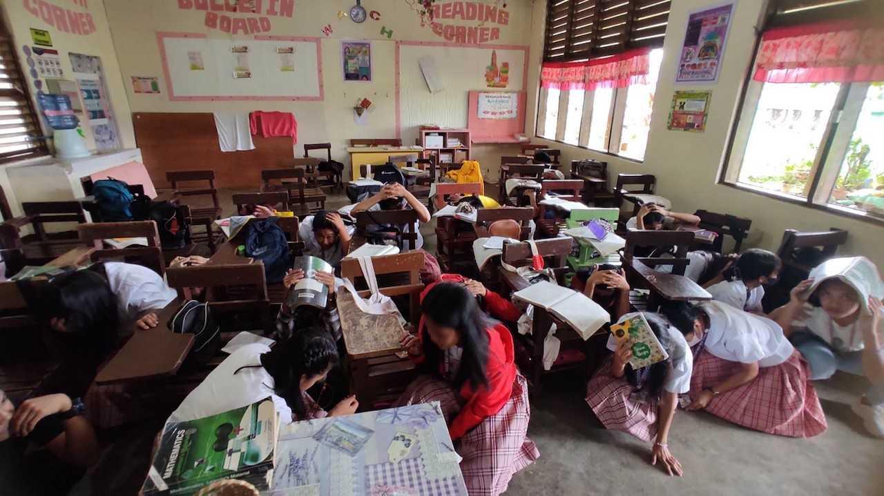 This handout photo taken and received from Buso National High School on March 7 shows students taking shelter inside their classroom in Mati, after a 6.0-magnitude earthquake jolted the southern Philippines. Photo: AFP