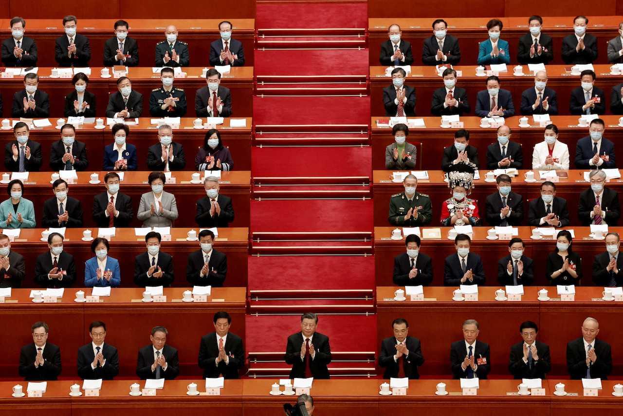 Chinese President Xi Jinping and other officials applaud at the opening session of the National People's Congress at the Great Hall of the People in Beijing, China, March 5. Photo: Reuters