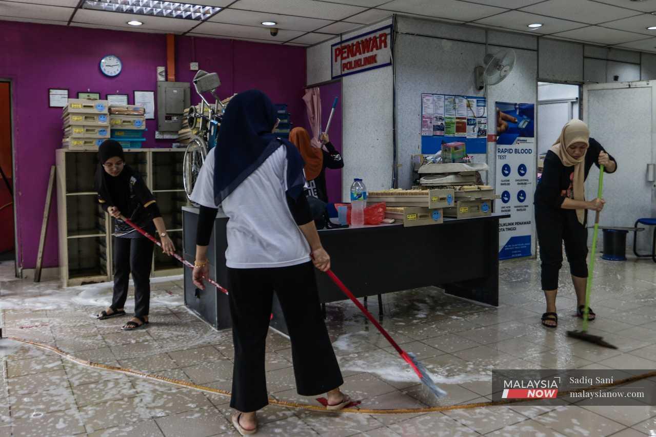 Staff clean out the reception area of a clinic in Kota Tinggi, Johor. 