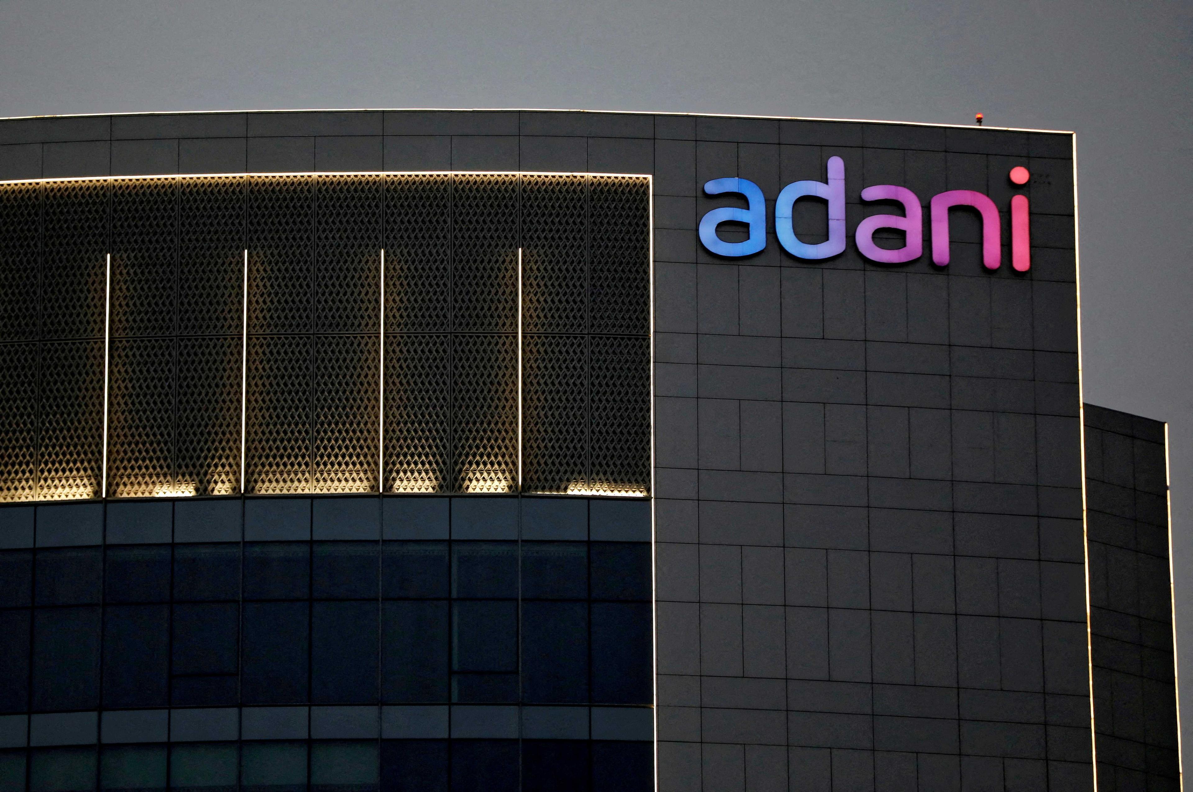 The logo of the Adani group is seen on the facade of one of its buildings on the outskirts of Ahmedabad, India, April 13, 2021. Photo: Reuters