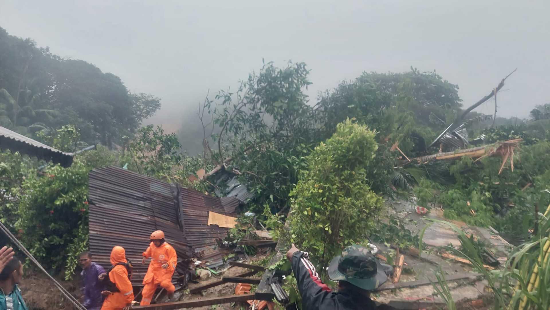 This handout photo released by the Indonesian National Disaster Management Agency shows a search and rescue team at a site in a village after landslides in Natuna, Riau province on March 6. Photo: AFP