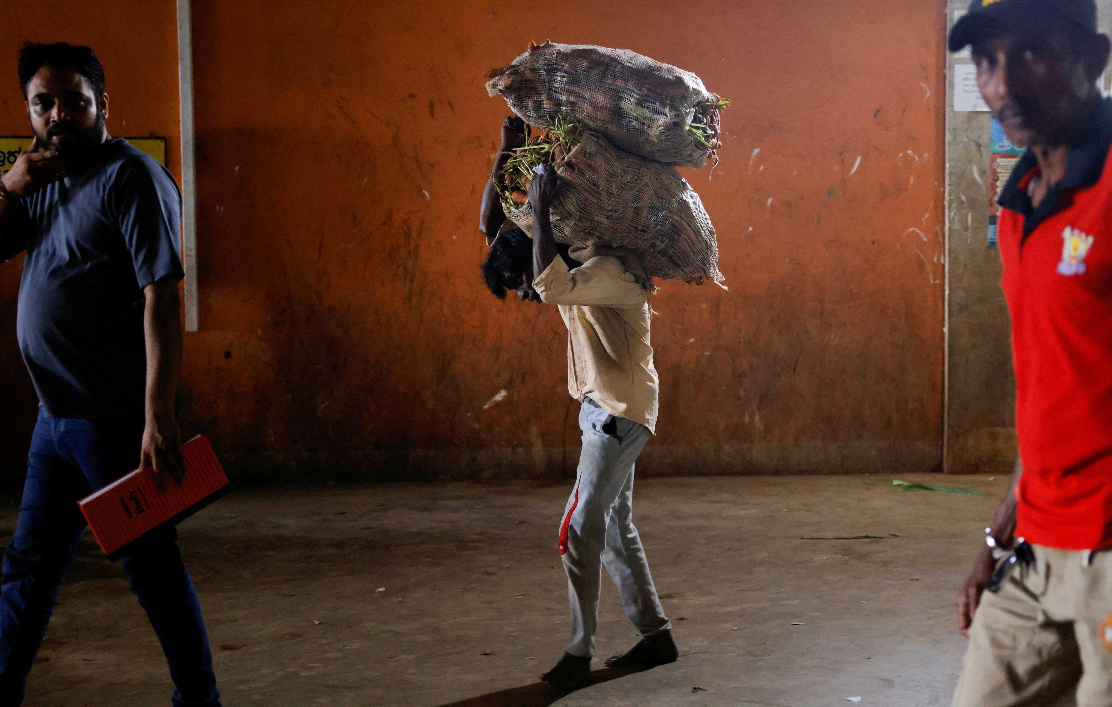 A man carries a sack of vegetables at a main market in Colombo, Sri Lanka Feb 10. Photo: Reuters