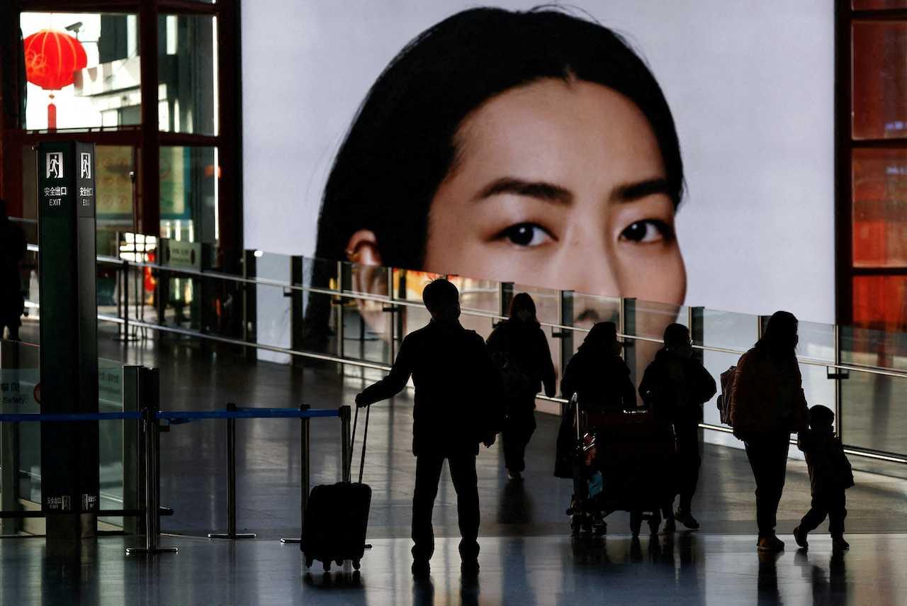 Travellers walk at a terminal hall during the annual Spring Festival travel rush ahead of the Chinese Lunar New Year, at Beijing Capital International Airport, Jan 18. Photo: Reuters