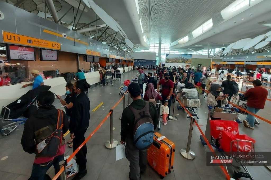 Passengers queue at a ticket counter at klia2 in Sepang in this file photo.