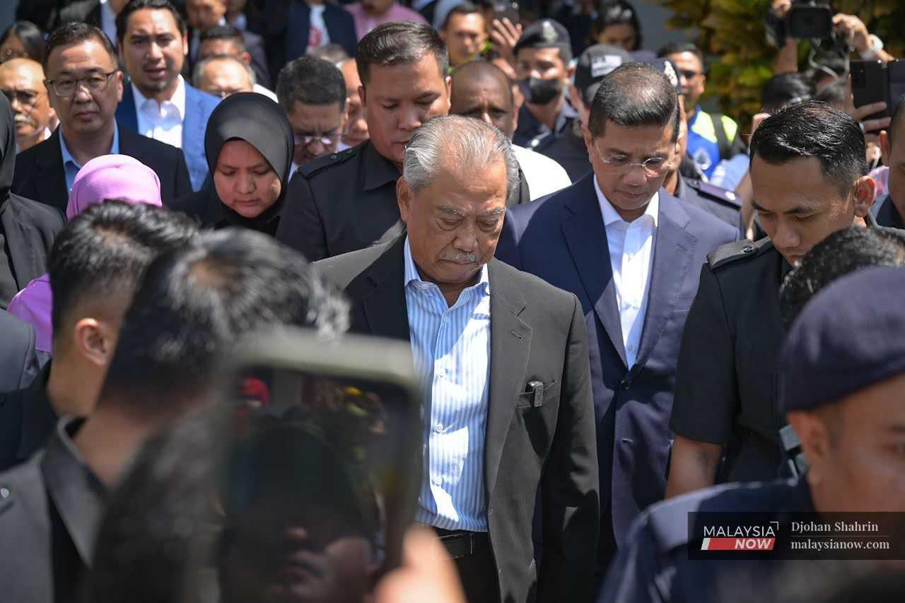 Former prime minister Muhyiddin Yassin leaves the Kuala Lumpur court complex after being charged with corruption and money laundering, March 10. 
