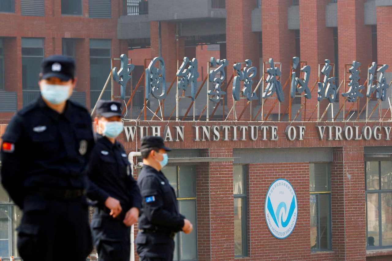 Security personnel stand outside the Wuhan Institute of Virology during a visit by a World Health Organization team tasked with investigating the origins of Covid-19, in Wuhan, Hubei, China, Feb 3, 2021. Photo: Reuters
