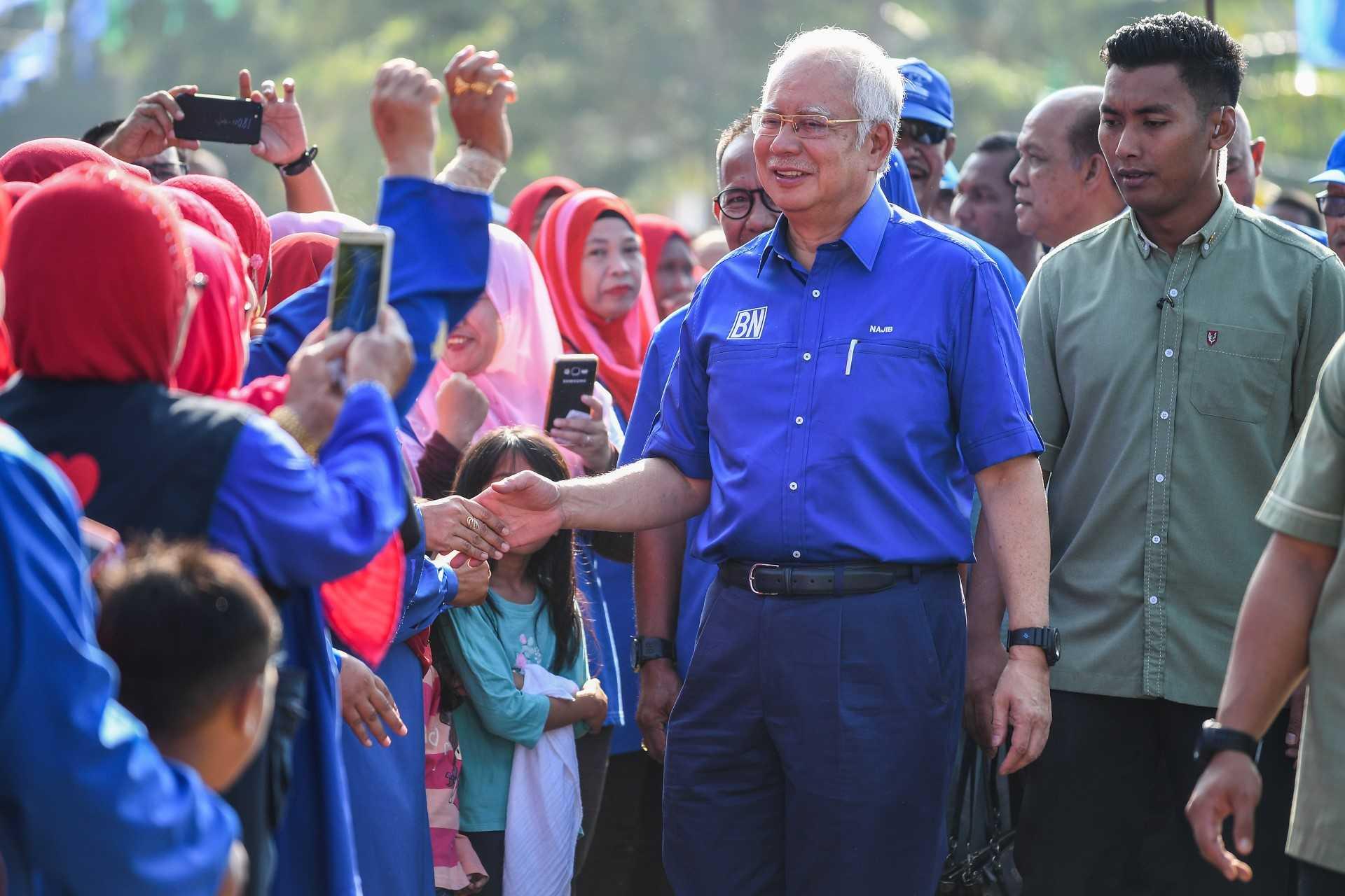 Former prime minister Najib Razak shakes hands with his supporters on the campaign trail ahead of the 14th general election in Pekan, Pahang, May 6, 2018. Photo: AFP
